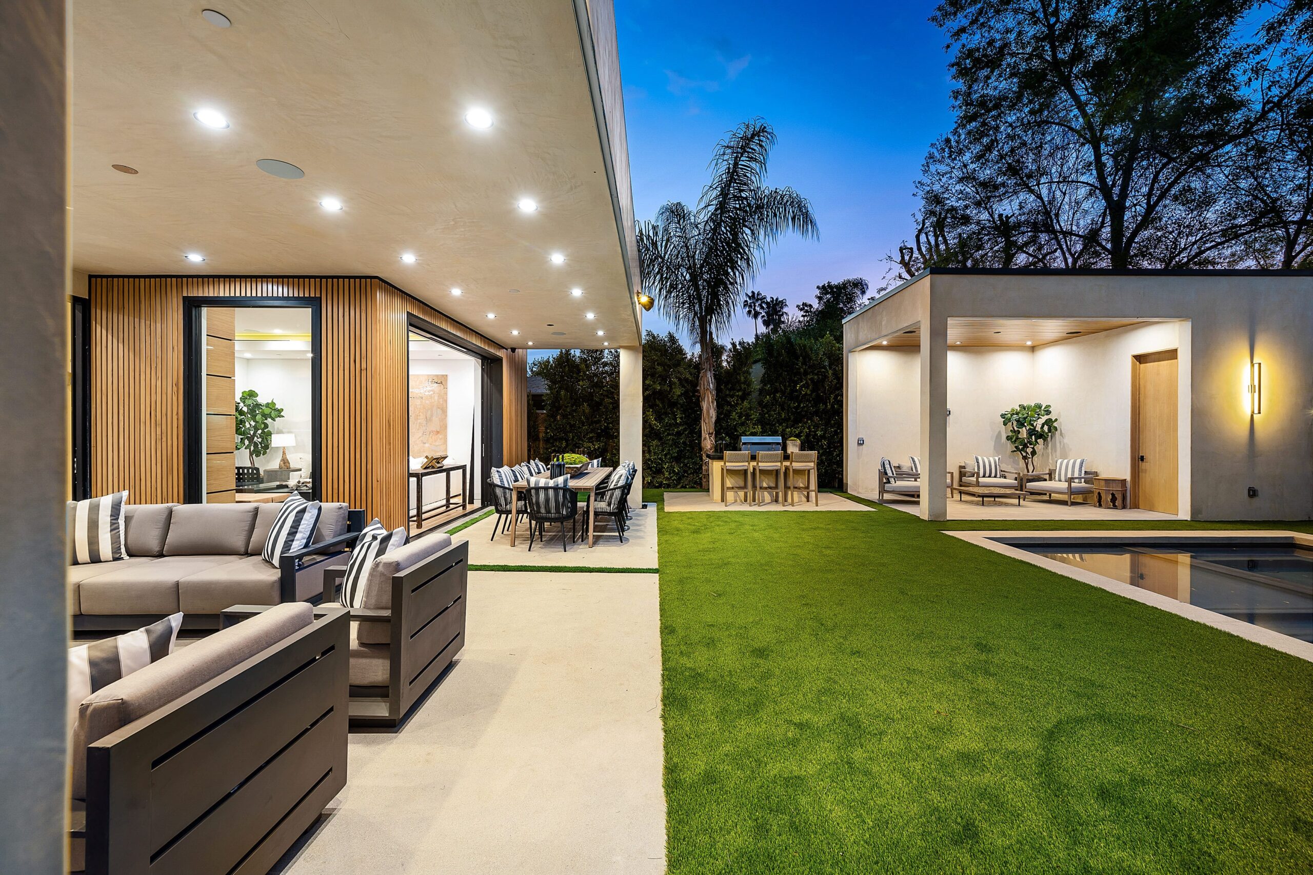 Transform your backyard into a green retreat with an artificial grass patio